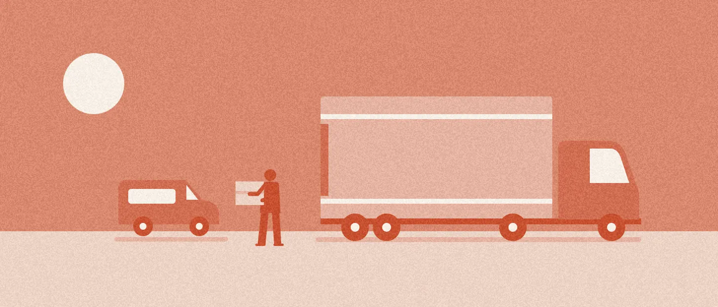 Un homme porte un seul carton entre une petite camionnette et un grand camion vide